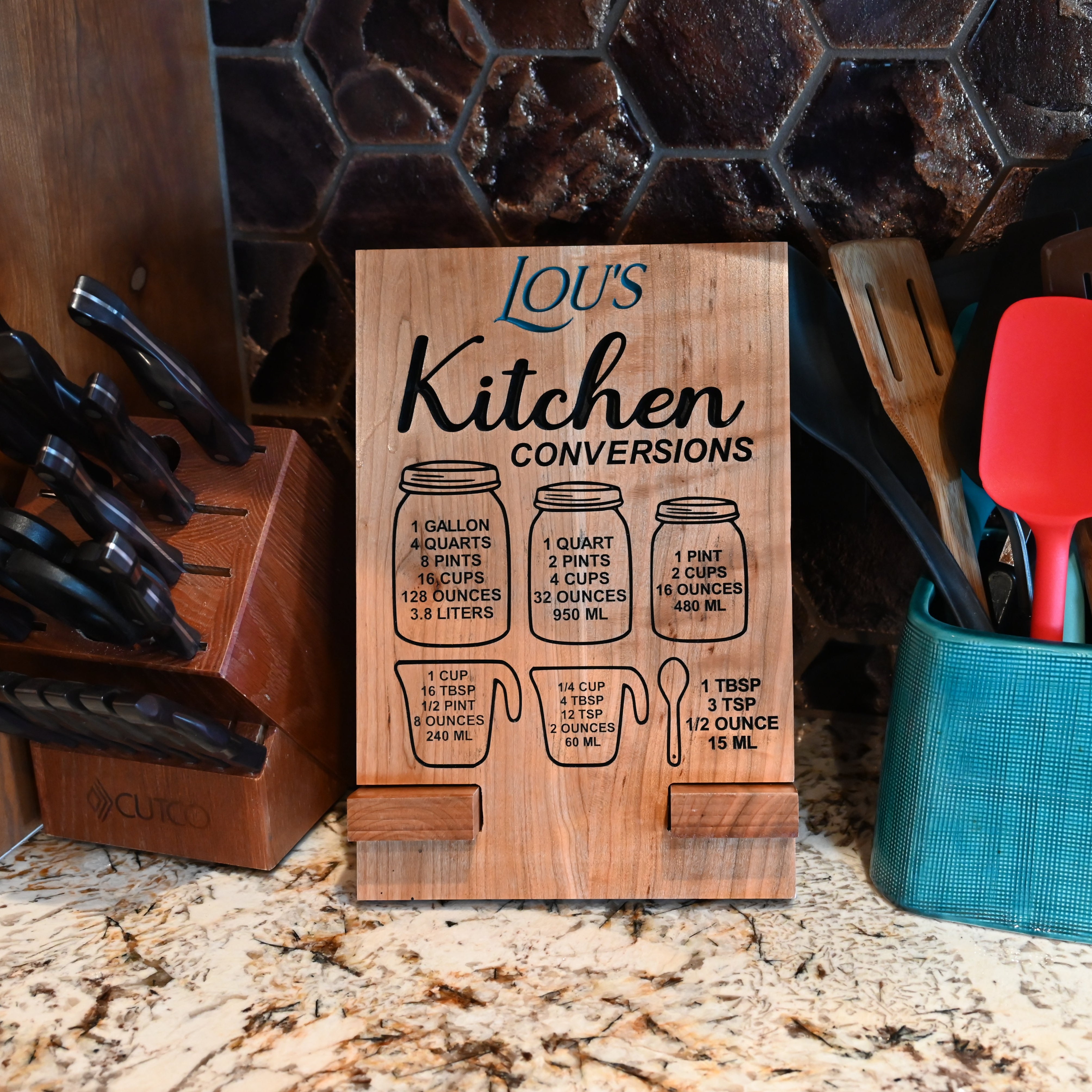 Photo of a personalized wood cookbook - tablet stand with kitchen conversion sitting on a countertop.