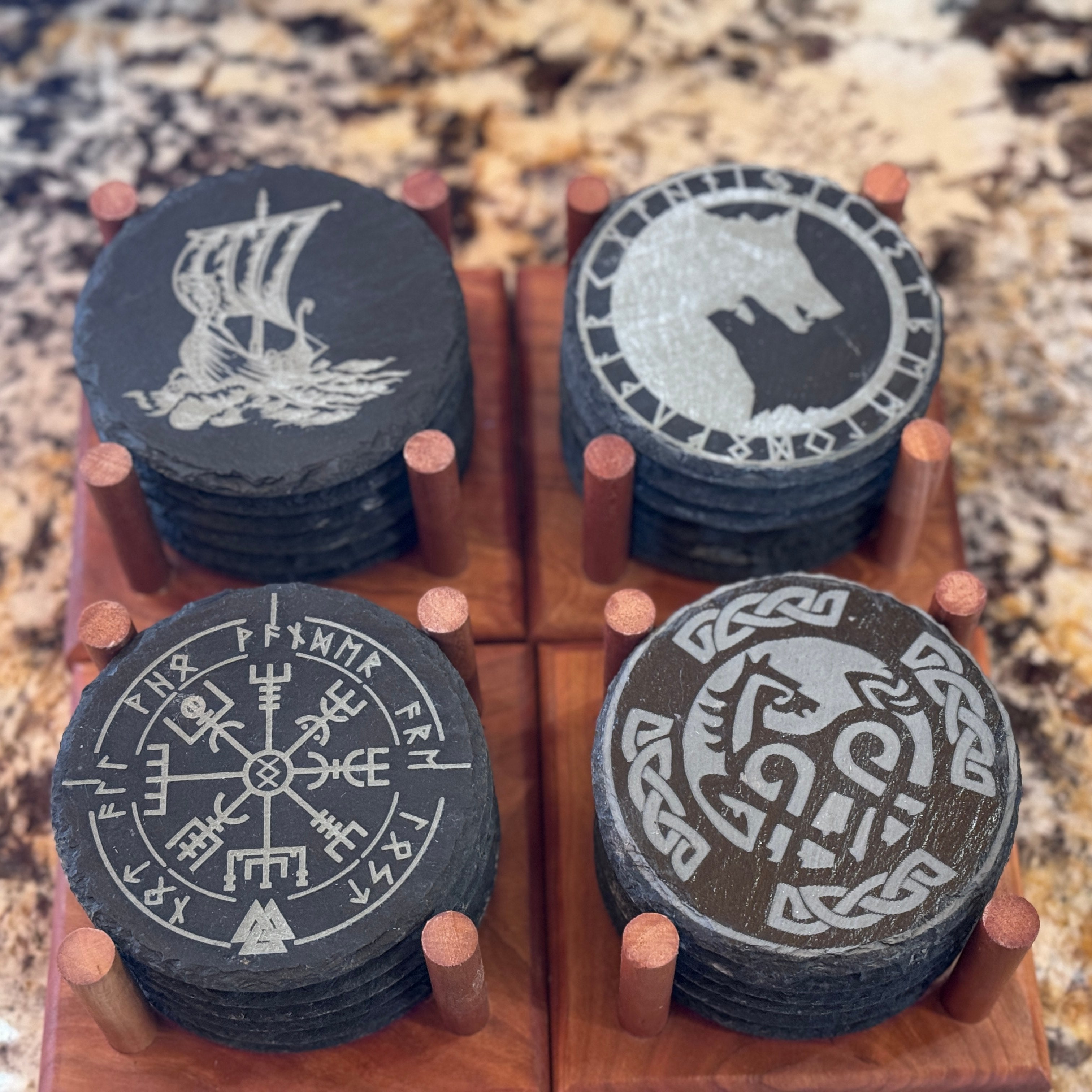 Photo of slate coasters with Viking Symbols in coaster holders.